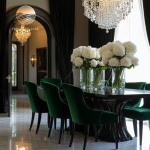 Classic dining room with deep green velvet chairs, black curtains, white floral arrangements, and crystal chandeliers.