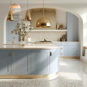 A kitchen with golden pendant lights, blue cabinetry, and a marble island with a modern design.