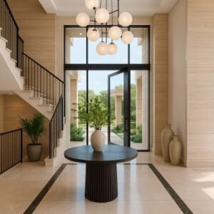 Elegant foyer with chandelier, large round table, and floor-to-ceiling windows