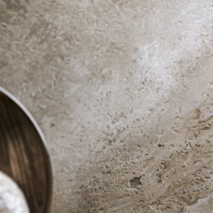 Close-up of textured plaster and stone finishes in a luxury interior